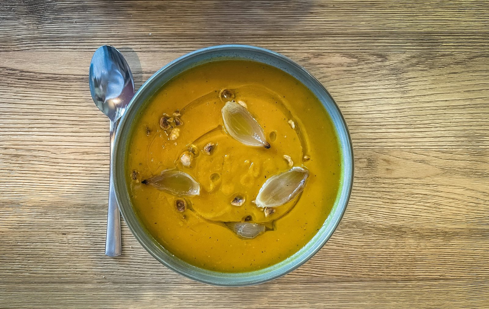 a bowl of soup on a wooden table