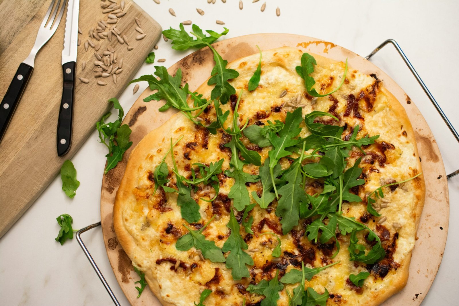 a pizza sitting on top of a wooden cutting board